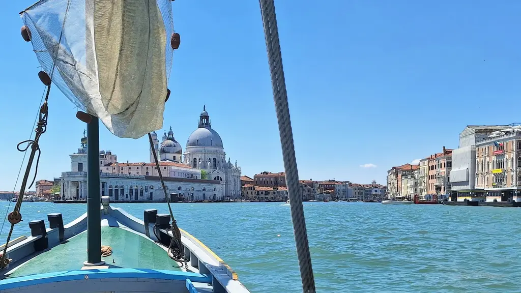 The Bragozzo Stella, a classic 1965 boat, sailing towards Punta della Dogana and Basilica Salute